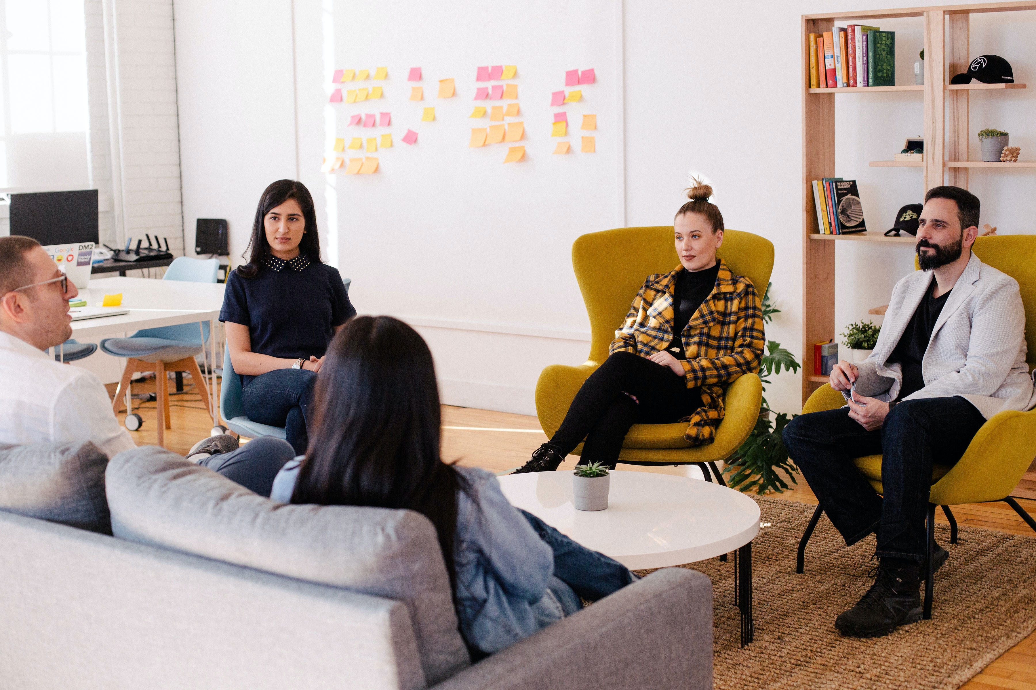 Employees seated at a table in an office during a meeting